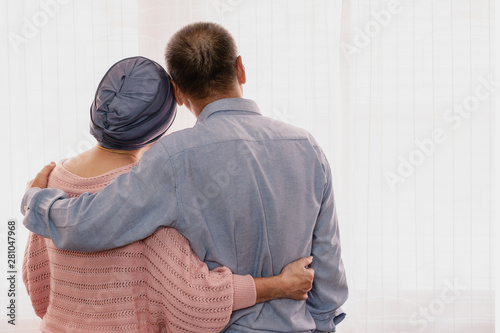 senior couple holding together with hands showing love and concern when wife wearing headscraf having cancer and cure with chemotherapy photo