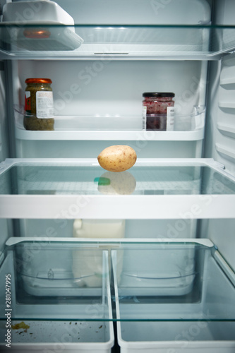 View Looking Inside Refrigerator Empty Except For Potato On Shelf