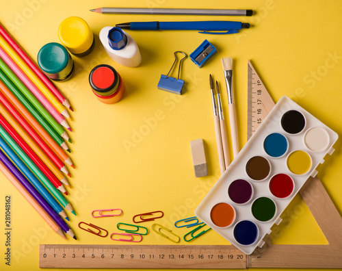 school supplies at abstract colorful background texture