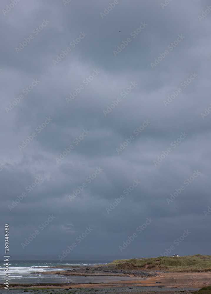 Westcoast Ireland. Ocean. Lonely house. Dark clouds
