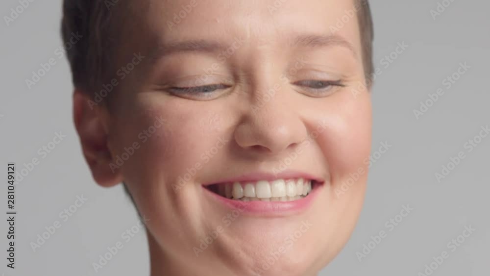 caucasian blue eyed model alone in studio portrait bite her lips, smiling, showing her tongue Closeup face portrait making faces caucasian blue eyed model alone in studio portrait bite her lips, smiling, showing her tongue Closeup face portrait making faces