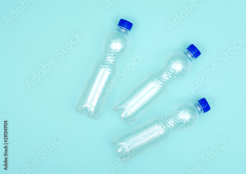 Plastic bottles on blue background. Glare on bottles