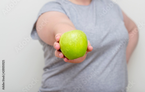 A young overweight woman chooses healthy food, copies space. Diet, healthy eating, weight loss, slimmimg photo