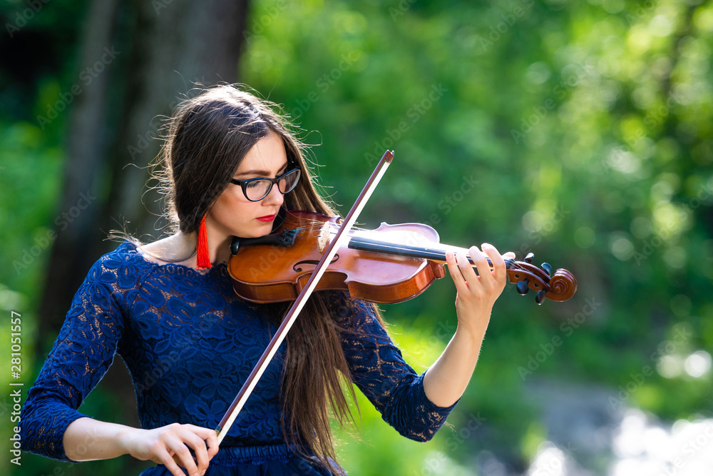 Young woman playing the violin at park. Shallow depth of field - image Young woman playing the violin at park. Shallow depth of field - image