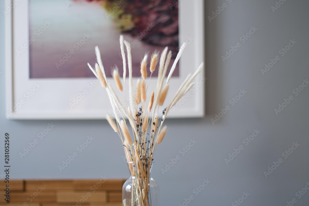dried flowers in a vase on the background of the interior of the cafe