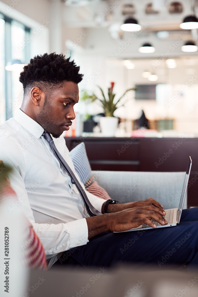 © Monkey Business - Businessman Working On Laptop At Desk In Shared Workspace Office © Monkey Business - Businessman Working On Laptop At Desk In Shared Workspace Office