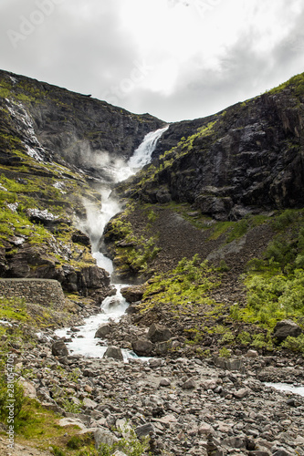 Trollstigen waterfall on serpentine mountain road, Norway photo