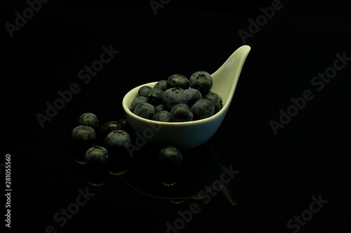 great image for the kitchen, on a black background blueberries for healthy people