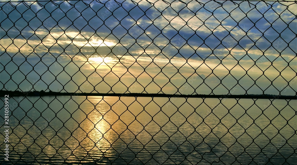 Sunset behind the fence Sunset behind the fence