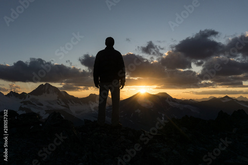 Silhouette of a man on a background of mountains at sunset