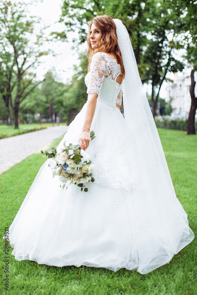 beautiful bride in nature, portrait of a girl in a white dress