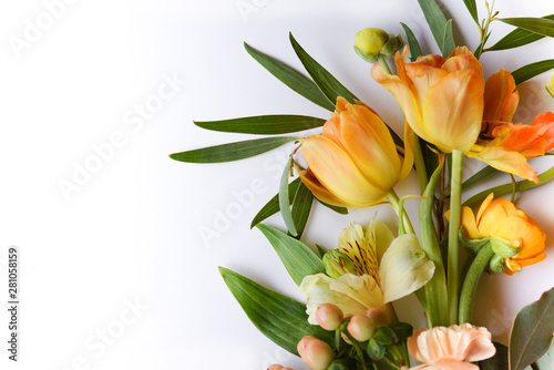 Horizontal image of fresh cut flowers and greenery on a white background with copy space