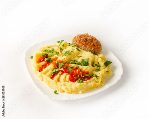 Chicken cutlet with mashed potatoes and chopped herbs on white background