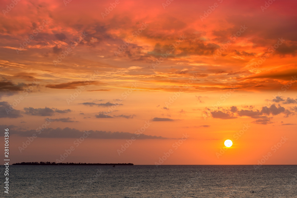 seascape horizon golden yellow light at dusk or dawn with a dramatic red clouded sky