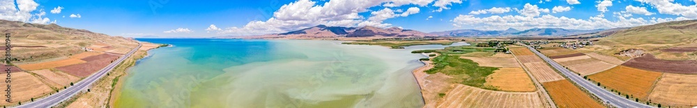 Aerial view of Lake Van the largest lake in Turkey, lies in the far east of that country in the provinces of Van and Bitlis. Fields and cliffs overlooking the crystal clear waters. Road