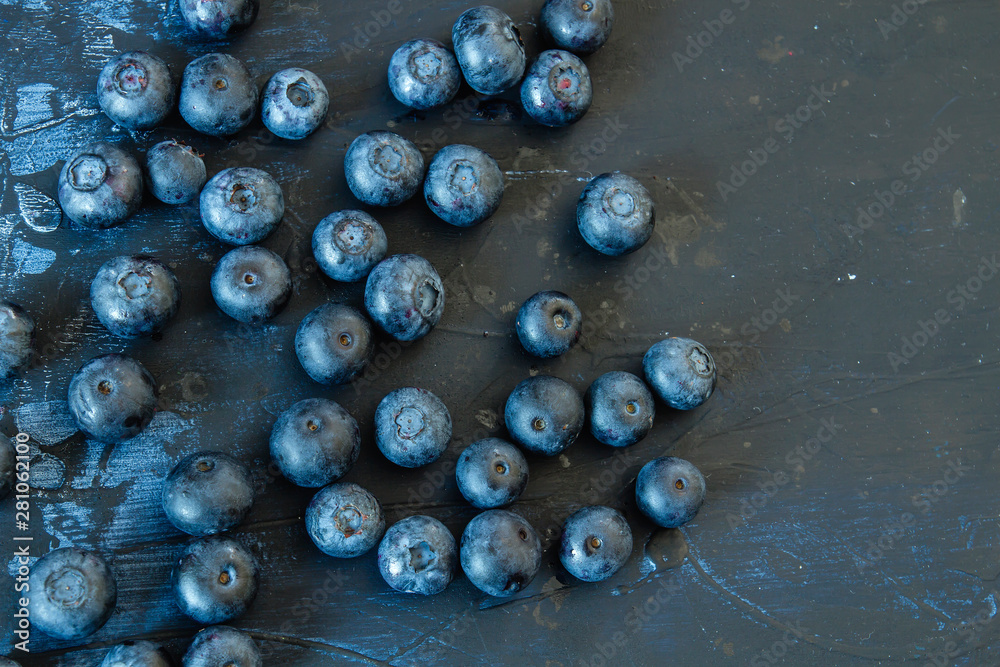 Fresh wild hand-picked blueberries on a dark wooden table Fresh wild hand-picked blueberries on a dark wooden table