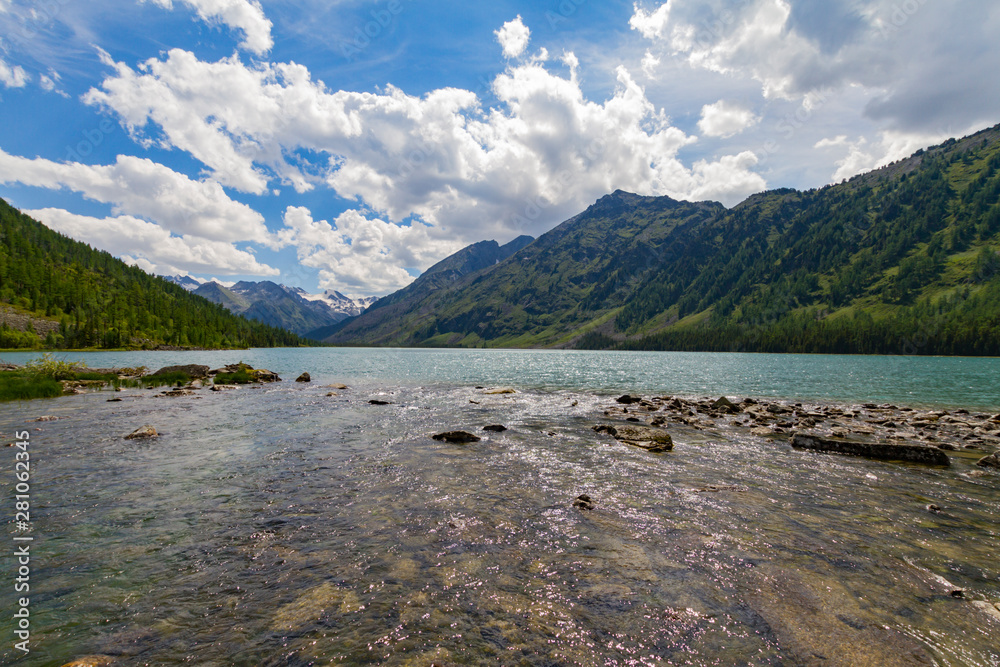 Multinsky averadge lake in Altai mountains. Picturesque landscape with transparent water. Summer touristic concept.