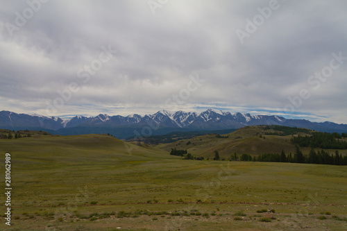 Snow tops in Altai mountains. Long shot. Panaramic view. Summer time.