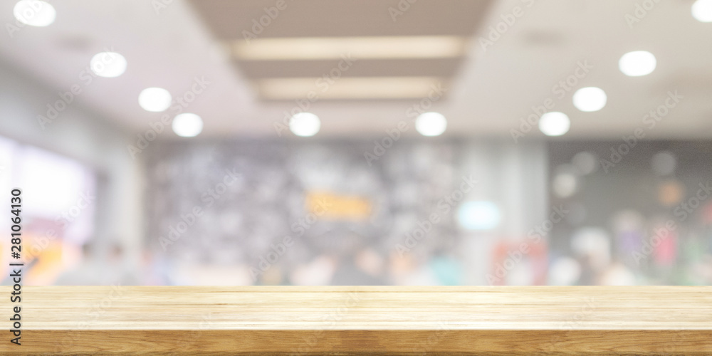 Empty wooden table top with blurred restaurant or cafe light background. Panoramic banner. Abstract background.