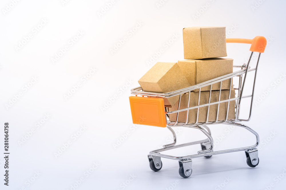 Paper boxes in shopping cart with copy space on white background.
