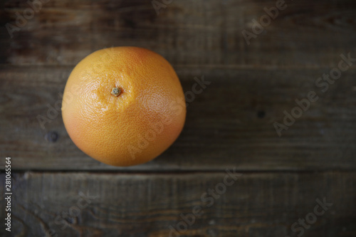 Fresh red grapefruit on rustic wooden background. Top view. Flat lay. With copy space for text. Healthy food, diet concept, detox.