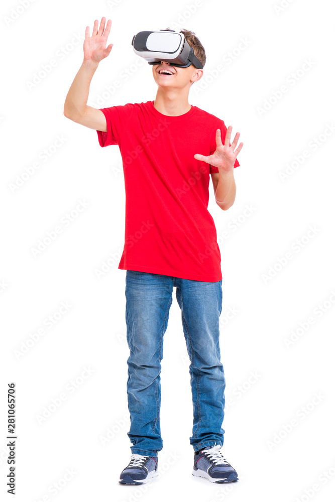 Full length portrait of young caucasian teen boy using virtual reality goggles. Funny teenager looking in VR glasses. Handsome child experiencing 3D gadget technology, isolated on white background. Full length portrait of young caucasian teen boy using virtual reality goggles. Funny teenager looking in VR glasses. Handsome child experiencing 3D gadget technology, isolated on white background.