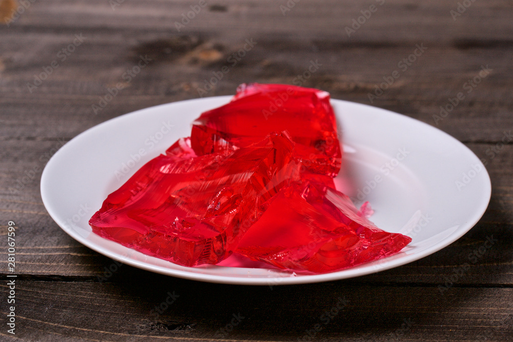 Berry jelly in a white plate on a wooden table Berry jelly in a white plate on a wooden table