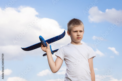 Boy with airplane sky background