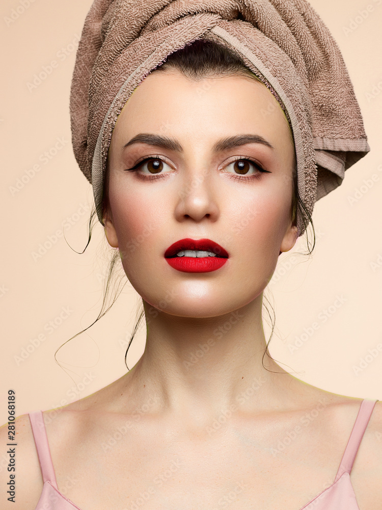 Beauty girl closeup with evening make-up. Graphic arrows on the eyes. Sensual sexy full red lips. Head towel and clean skin after spa treatments. A high resolution Beauty girl closeup with evening make-up. Graphic arrows on the eyes. Sensual sexy full red lips. Head towel and clean skin after spa treatments. A high resolution