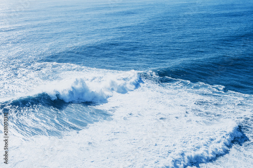 View of the blue sea or ocean with foam and waves background.