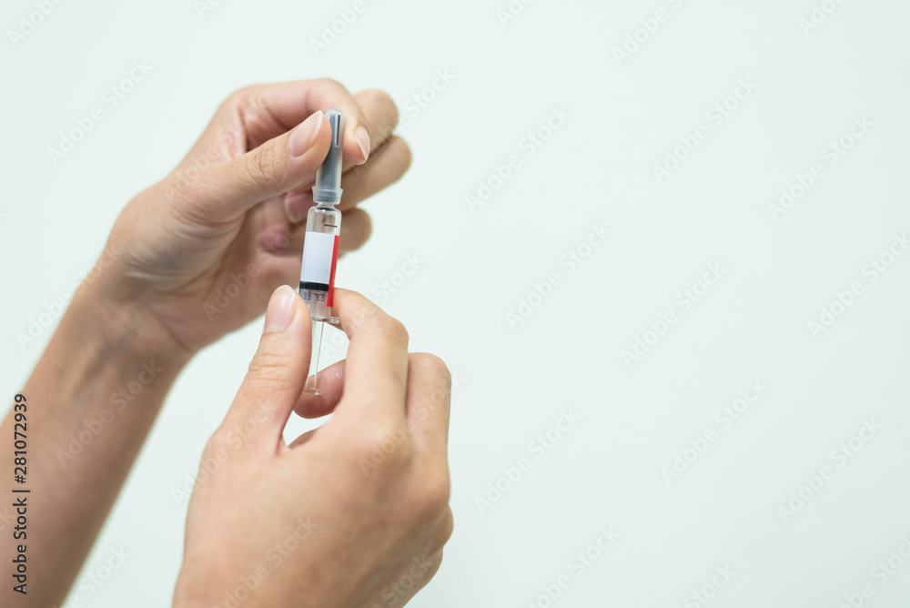 Close up doctor's hand holding syringe for vaccine to patient on white background.Nurse using syringe are vaccination to patient for influenza protection.Medication treatment concept. Close up doctor's hand holding syringe for vaccine to patient on white background.Nurse using syringe are vaccination to patient for influenza protection.Medication treatment concept.