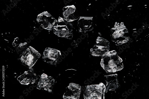 Canvas Print top view of melting transparent refreshing ice cubes isolated on black