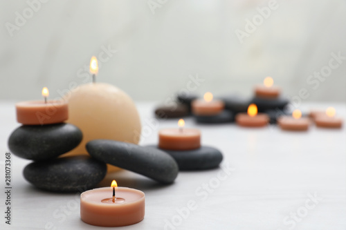 Composition with spa stones and candles on white table