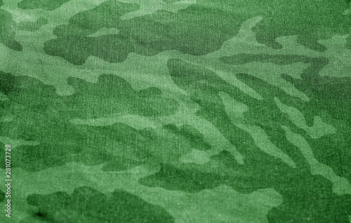 Dirty camouflage cloth with blur effect in green tone.