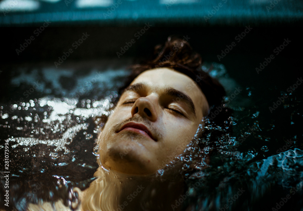 Fototapeta premium Portrait of young man in hot tub