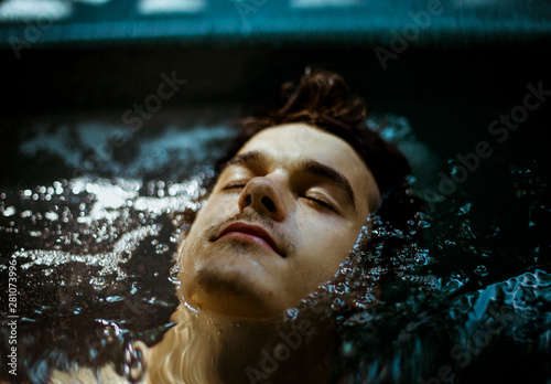 Portrait of young man in hot tub 