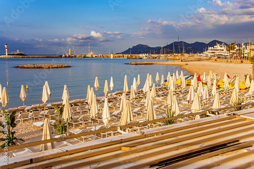 Sea bay with yachts boats and beach umbrella in Cannes