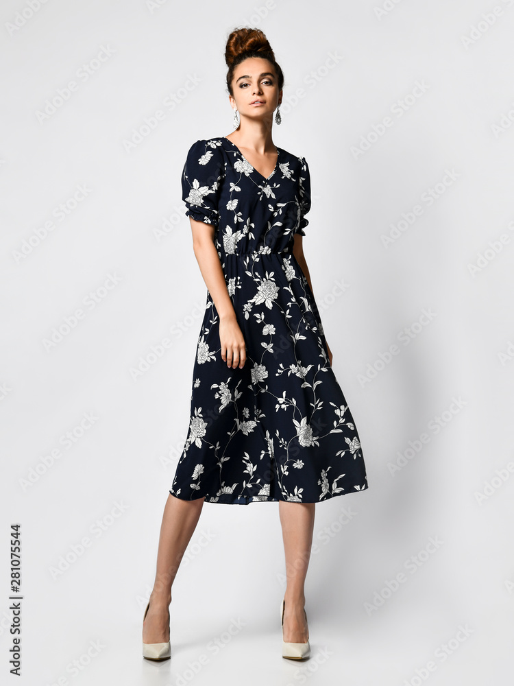 Slim curly female model in a silk pale dress looking at the camera in full growth. Cute girl in romantic clothes is going on a date Slim curly female model in a silk pale dress looking at the camera in full growth. Cute girl in romantic clothes is going on a date