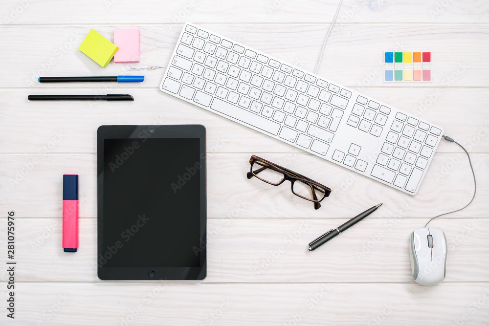 Workspace with keyboard, tablet and office supplies on white color background. Top view. Flat lay style. Mock up Workspace with keyboard, tablet and office supplies on white color background. Top view. Flat lay style. Mock up