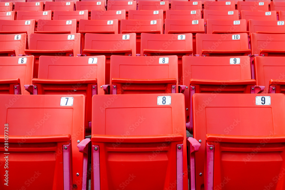 Fototapeta premium Row of red folding chairs in a stadium. Sport concept.