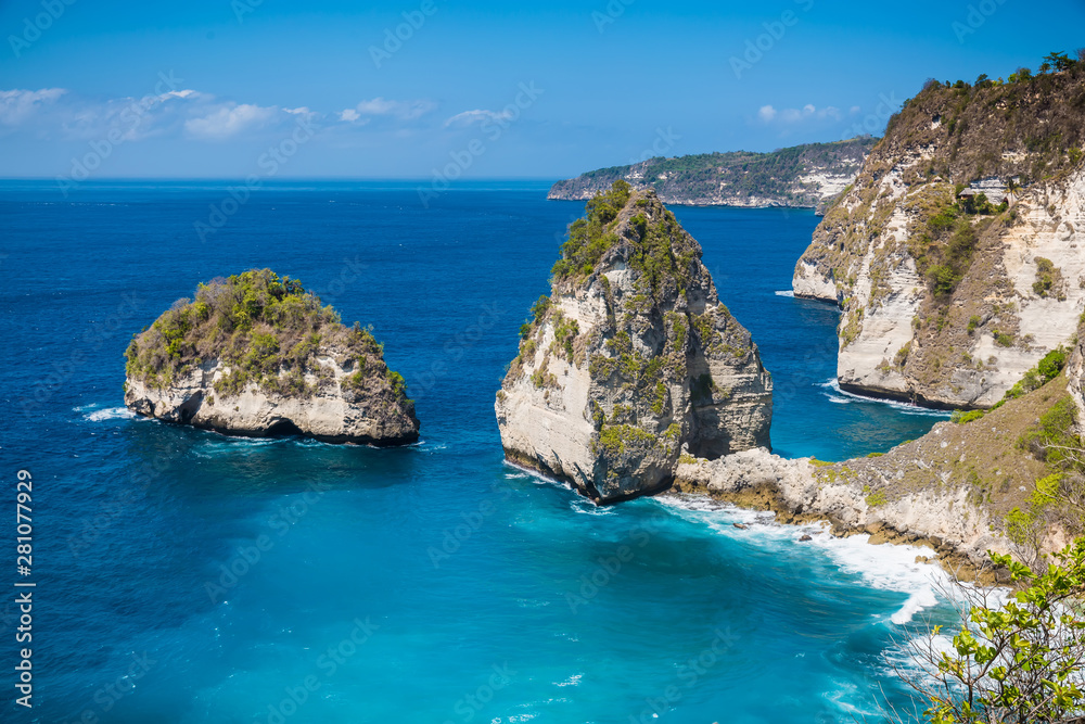 Rocks in ocean at Nusa Penida, Indonesia. Rocky cliff and turquoise Water.