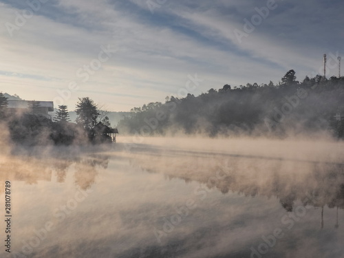 Lake view misty morning of reservoir around with soft mist with yellow sun light in the sky background, sunrise at Ban Rak Thai, Mae Hong Son, northern of Thailand.