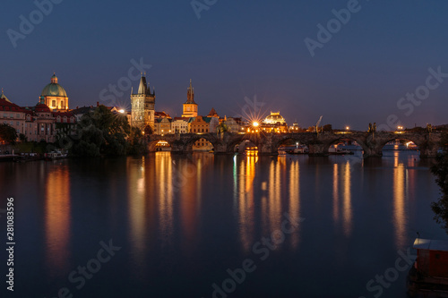 Pananorma view over the river Vltava. Old Town Prague at night with the historic stone bridge. Charles Bridge with illuminated Old Town tower and reflections in the water © Marco