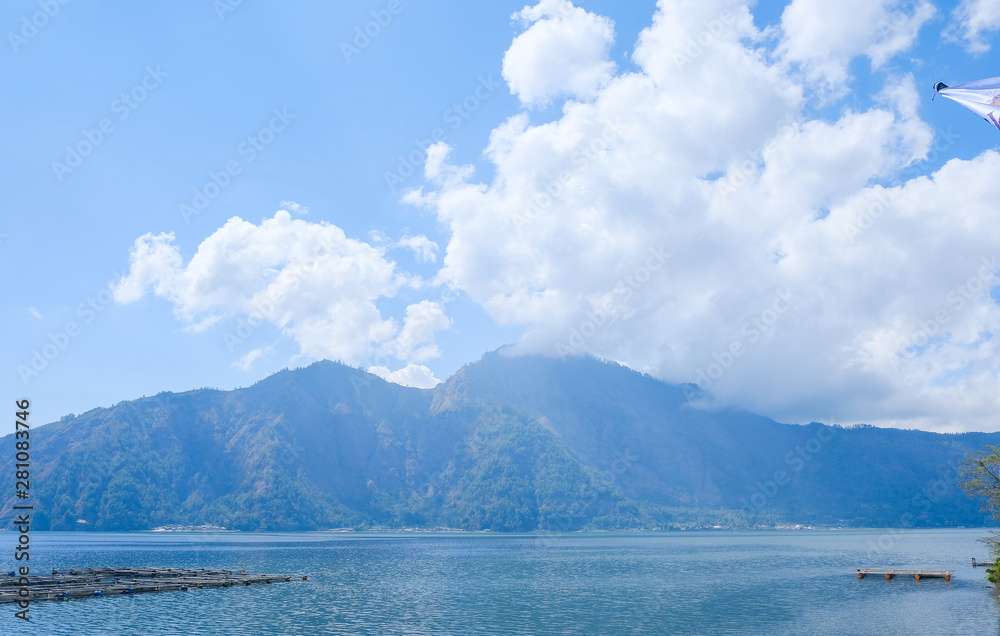 Lake Batur and the volcano are located in the Central mountains on the island of Bali, near the village of Kintamani, Indonesia. Mountain landscape. Lake Batur and the volcano are located in the Central mountains on the island of Bali, near the village of Kintamani, Indonesia. Mountain landscape.
