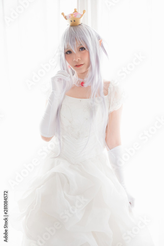 Portrait of vampire dracula young woman dress in white tone room halloween concept