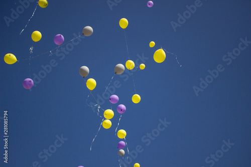 Balloons in the sky. Festive balloons fly through the air. Many balloons filled with helium and released up. Festive background.