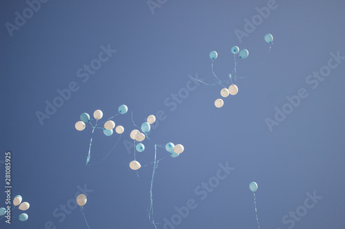 Balloons in the sky. Festive balloons fly through the air. Many balloons filled with helium and released up. Festive background.