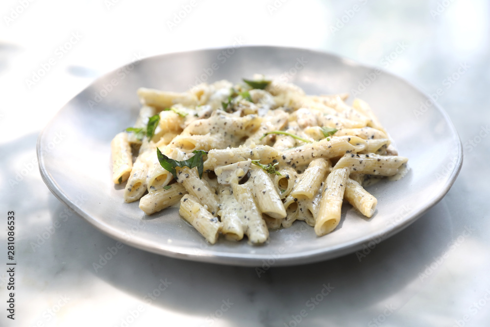 Penne pasta with white sauce and truffle , italian food Penne pasta with white sauce and truffle , italian food