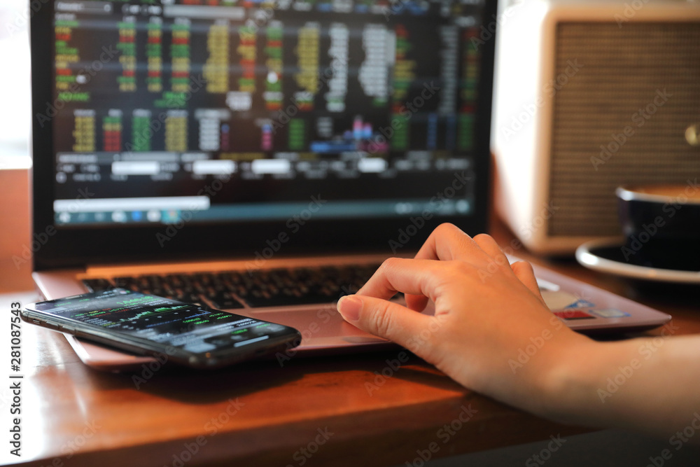 Fototapeta premium Woman hand working at coffee shop hand on keyboard with close up
