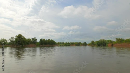 View from a motorboat going down the river at high speed. Spring flood in the Volga river delta. Russia, Astrakhan region, near the town of Kamyzyak. photo